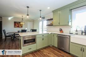 The Peninsula Bar Seating And Open Format Allow For Holiday Entertaining Needs Of Varyi Farmhouse Kitchen Remodel Home Remodeling Contractors Kitchen Remodel