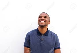 Portrait Of Smiling Young Black Man Looking Up Against White Stock Photo Picture And Royalty Free Image Image 82775446 How long can you stare without blinking? portrait of smiling young black man looking up against white