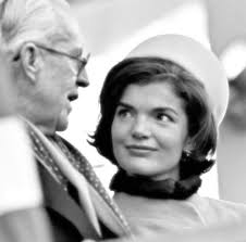 Joseph P. Kennedy, Sr. (center) holds his sons, Joseph P. Kennedy, Jr.  (left), and John F. Kennedy (right), near the home the family rented