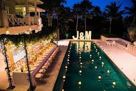 Vibrant Bali Wedding With A Hanging Botanical Installation Ruffled Pool Wedding Decorations Pool Wedding Wedding Pool Party