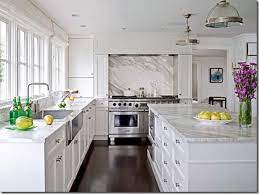 In a kitchen full of deep, dark colors, a marble countertop is a surefire way to add a dramatic pop of white that will also keep your kitchen feeling bright and cozy. White Quartz Countertops Dk Wood Floor Kitchen Inspirations Kitchen Marble Kitchen Flooring