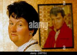 Elvis Presley fan, Mrs Valerie Constable wearing Elvis portrait earrings,  portrait of Elvis