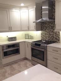 A pale mint kitchen with a white marble backsplash, countertops and an long open shelf. Trends Of 2018 13 Amazing Kitchen Backsplash Ideas Homify