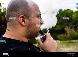 Man vaping in the street hi-res stock photography and images