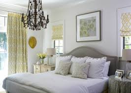 Elegant yellow and brown bedroom features a brown velvet art deco headboard placed in front of yellow stripe fabric and complemented with a an oak spindle bed is dressed in white and gray bedding and placed beside a white parsons end table lit by a gray lamp positioned next to a recycled. Yellow And Gray Decorating Ideas 20 Spaces Somewhat Simple