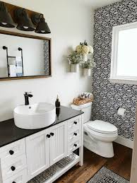 Modern farmhouse bathroom with rustic stool and wicker baskets. Modern Farmhouse Renovation Clark Aldine