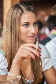 Willie perdomo brings a legendary roster of poets to celebrate his radically revised new edition smoking lovely: Young Lovely Woman In Dirndl Or Tracht Dress Sitting And Smoking At The Oktoberfest Stock Photo Picture And Royalty Free Image Image 44177592