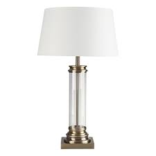 It has a simple, cylindrical shaped, white lamp shade. Traditional Glass And Antique Brass Table Lamp With Shade
