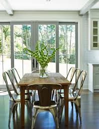 Collection includes dining table with four chairs and bench farmhouse style robins egg blue/teal color. Metal Drafting Table With Farmhouse Dining Room And Ceiling Beams Floral Arrangements Flower Arrangement Gray Trim Kitchen Dining Metal Chairs Metal Dining Chairs Rectangular Dining Table Sliding Glass Door Sunlight White Subway