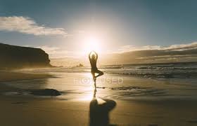 It improves had a great time at sunset beach yoga with a group of 7 friends. Woman Practicing Yoga On The Beach At Sunset Color Image 30 40 Years Stock Photo 177564622
