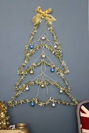 This Space Saving Tree Is Made Of Wire Hangers And It Hangs Flat On The Wall You Can Decorate It With Flat Christmas Tree Hanger Christmas Tree Hanger Crafts