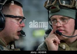 A U.S. Army nurse talks with a patient. Country: Unknown Stock Photo