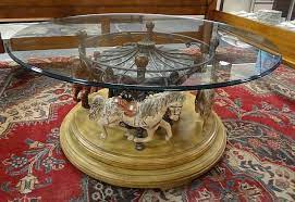 The weathered paint and finish on this large horse makes it look like a true vintage find. Lot Glass Top Carousel Coffee Table Rotates