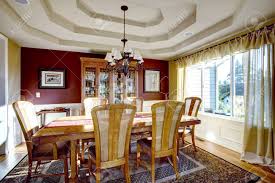 Family room design ideas yellow walls burgundy curtains. Dining Room With Coffered Ceiling Burgundy And Yellow Walls And Hardwood Floor Wooden Cabinet With Glass Door And Dining Table Set Stock Photo Picture And Royalty Free Image Image 31386156