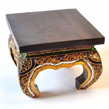 The table depicts an archer driving a battle chariot pulled by two horses outside a walled city. Opium Table Solid Teak Wood Decorated Black 25cm