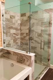 A half wall (also called a knee wall) is a great way to divide a space without closing it in. Custom Shower Door Installation Glass Doctor
