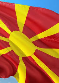 The flag of north macedonia is the national flag of the republic of north macedonia and depicts a stylized yellow sun on a red field, with eight broadening rays extending from the center to the edge of. Macedonia Flag The Globalist