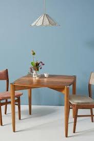 Table with bsl top of 25mm thick side edges finished with pvc edge banding supported by m.s bracket, centre pipe of 75mm with chrome polish. Corbyn Square Wood Tapered Dining Table