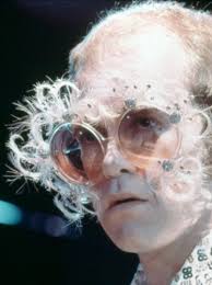 Elton John in feather glasses 🕶️