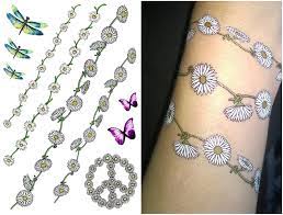 White tattoo designs are growing in popularity. Funky Festival Flower Tattoos Daisy Chain Butterfly Etsy Daisy Chain Tattoo Ankle Daisy Chain Tattoo Hippie Tattoo