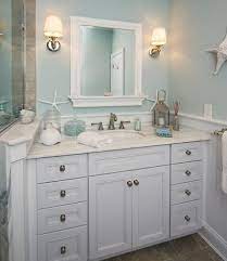 I like the double vanity with the cabinet between them up to the ceiling. Elements Of A Cape Cod Bathroom Design For A Luxurious Small Bathroom Cottage Bathroom Traditional Bathroom Beach Theme Bathroom