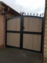 Backyard metal gates with wood infill. With Composite Infill To Look Like Wood Without Any Of The Hassle You Wouldn T Even Notice Gates Railings Wrought Iron Gates Iron Gates