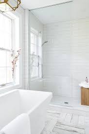Enjoy A Warm Bath After A Long Day In A Modern Freestanding Bathtub Placed On White And Gray Distresse White Bathroom Tiles Bathroom Tile Designs Tile Bathroom