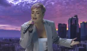 Lovato did a rendition of bill withers' classic single lovely day. she performed in front of a panel of screens, where a number of people (including some celebrities). Demi Lovato Wears Gray Suit For Celebrating America Performance Footwear News