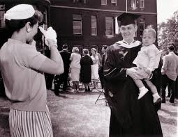 Young professor, Dr. Covert, holding his son, Marc, while wife, Sally,  takes photo, August 1961 (University Archives)