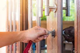 You can use shoe laces tied into a slip knot and work the thin rope between the door and the frame. Key On Hand Of People Open The Door To Inside Outside Door Open Stock Photo Picture And Royalty Free Image Image 131911359