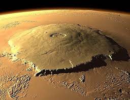 Olympus mons (latin for mount olympus) is a very large shield volcano on the planet mars. Olympus Mons The Martian Wikia Fandom