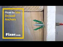 Push the toggle through the hole in the wall. Diy How To Hang Things On Drywall Fixer Com
