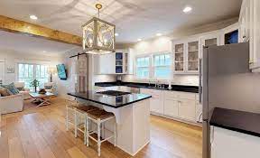 While white kitchen cabinets are classic and colorful kitchen cabinets are, we're ready for something a little moodier: White Kitchen Cabinets With Dark Countertops Designing Idea