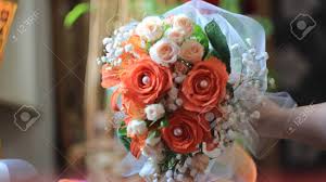 For decades, recipients have associated the lily with happiness, joy, love, sophistication, and elegance. Holding Of A Wonderful Wedding Bouquet With Orange Roses Lilies Pearls White Stock Photo Picture And Royalty Free Image Image 80992707