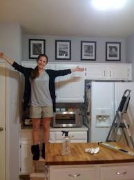 I Always Think Of Putting Stuff On Top But Never Hanging Art I Love This Fill The An Decorating Above Kitchen Cabinets Above Kitchen Cabinets Above Cabinets