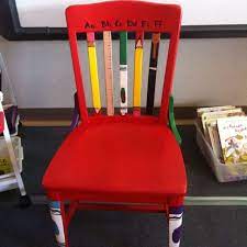 cute teacher chair love the pencils and crayons painted on this could also be my writers chair teacher chairs painted teacher chair authors chair