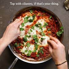 The Ideal Sunday Morning Involves Eggs Baked In Spiced Tomato Sauce With Feta And Lots Of Pita Bread Get Clarkbar S Shaksh Nyt Cooking Shakshuka Baked Eggs