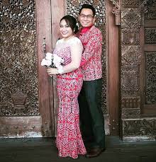 Young couple holding hands, looking at each other in a bright sunshine by the deep lake. Custom Made Pua Kumbu Dress Blazer By M O Couture Wedding Sarawak If You Decide You Want A Custom Made Dress Tha Dresses Designer Dresses Dress Collection