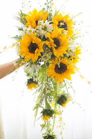 The pros mixed both large and small sunflowers with sizable dahlias and tiny blue and purple buds. Pin On Everything Wedding