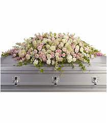Position the floral foam in the casket saddle, a container that fits over a casket and is designed to hold floral foam. Flowers For The Casket