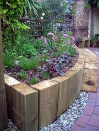 You can use garden sleepers in case you want to make a beautiful garden pathway. Use Vertical Railway Sleepers To Create A Curved Wall Raised Beds Curved Walls May Work With Over Front Garden Design Small Front Gardens Small Garden Design