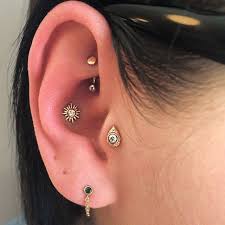 Yesterday I Had The Pleasure Of Doing This Beautiful Trio A Rook Conch And Tragus Piercing With Matching 14g Gold Piercings Earings Piercings Ear Piercings