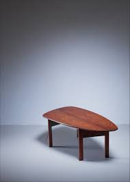 This perfectly original danish modern brazilian rosewood coffee table offers storage in a stunning, sleek cabinet. Large Free Form Danish Rosewood Coffee Table 1960s