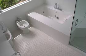 Bring the same bold style to your bathroom by creating a single statement wall with patterned tiles in a neutral hue. Indoor Tile Bom Daniel Ogassian Bathroom Floor Ceramic