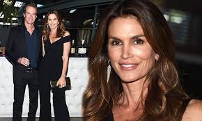 Cindy Crawford shows off her incredible figure in black plunging jumpsuit