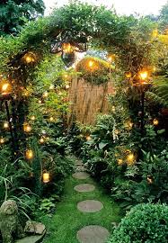Small Town Garden With Paving Slabs In Grass Beneath Arch With Lighting Wolverhampton Staffs In 2020 Magical Garden Witch Garden Witchy Garden