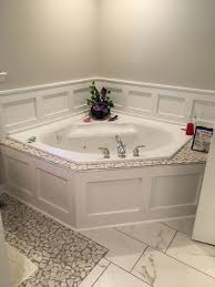 We recommend the loctite tub & tile adhesive caulk would be best for shower surrounds like stall, bathtub, tile etc. Wainscoting Around Garden Tub Cheap Fix For Broken Outdated Tile Tub Remodel Bathtub Surround Corner Tub