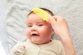 Mom Combs the Baby Hair and Collects it in a Ponytail