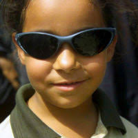 Three Iraqi women wait to exchange their Propane tanks at a distribution  site in Al-Kut, Iraq, during Operation IRAQI FREEDOM