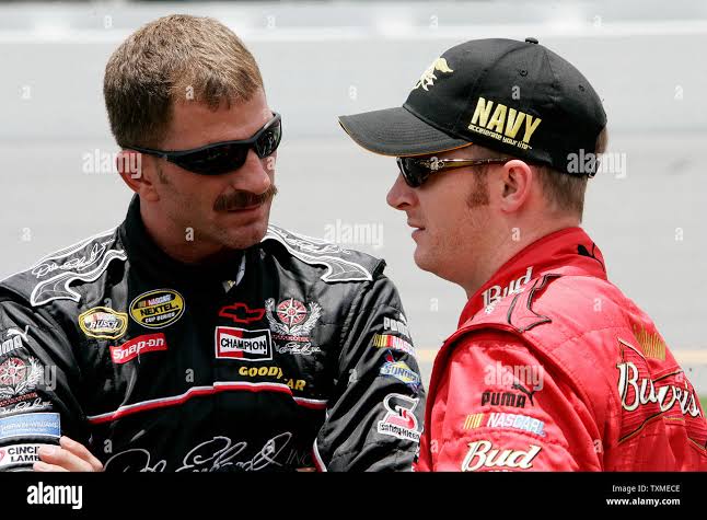 Dale Earnhardt Jr. (R) talks to his brother Kerry Earnhardt on pit row  prior to their qualifying runs for NASCAR Busch Series Winn Dixie 250 at  Daytona International Speedway in Daytona Beach,